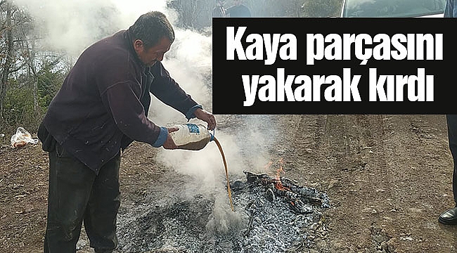 Kaya parçasını yakarak kırdı