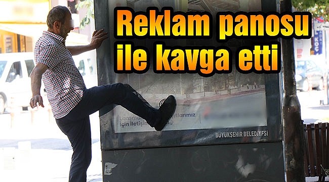 Reklam panosu ile kavga etti