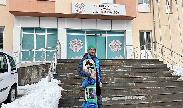 Karla kaplı yolda işine snowbordla kayarak gitti
